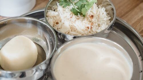 Free A delicious Indian meal served in stainless steel bowls on a tray, perfect for healthy eating. Stock Photo